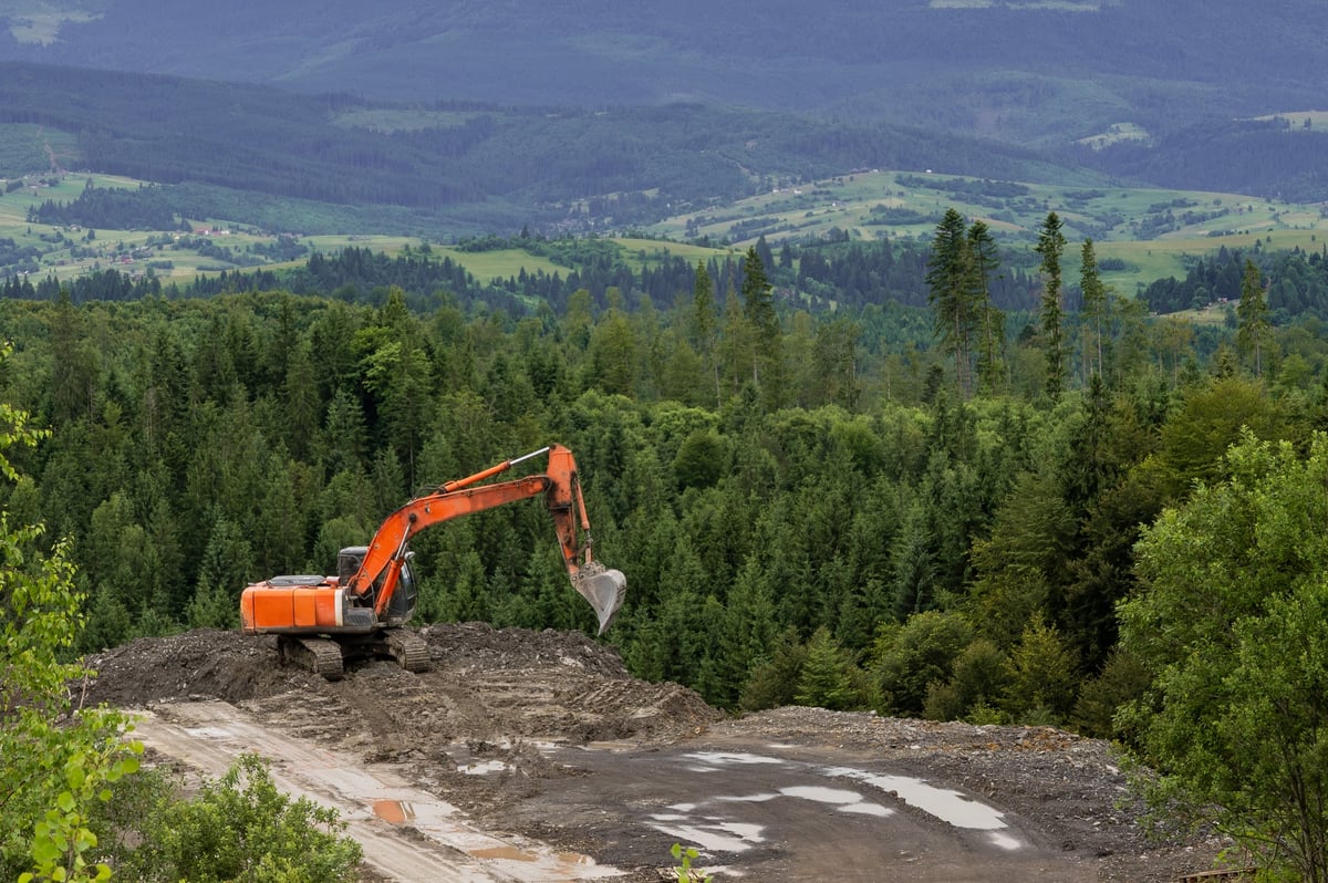 Excavator working on ground preparation for a horse arena